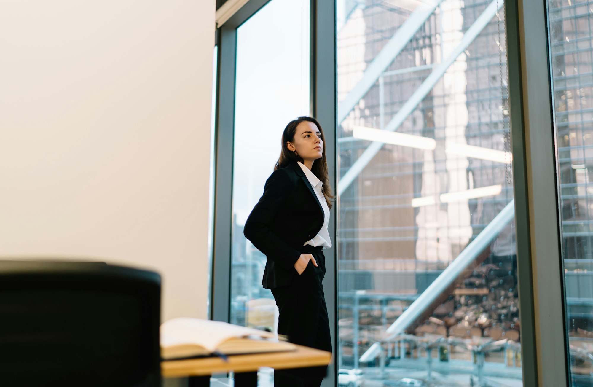Female manager standing near window in office